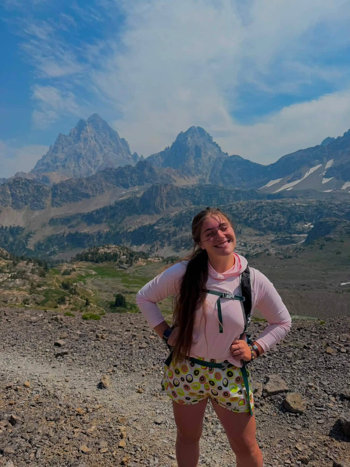 Hiker in the Confetti Sierra Shorts below jagged peaks