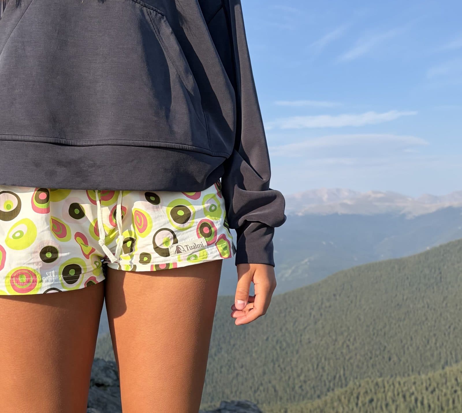 Confetti Sierra Shorts at altitude, mountains behind